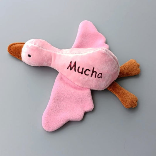 Personalized plush duck dog toy with custom name embroidery.
Handmade dog toy shaped like a duck with squeaker inside