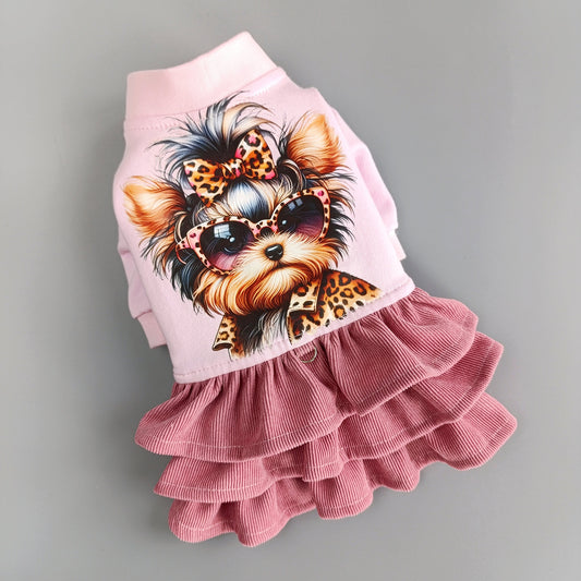 Close-up of the handmade pink dog dress showing leopard-print Yorkie and soft corduroy fabric.